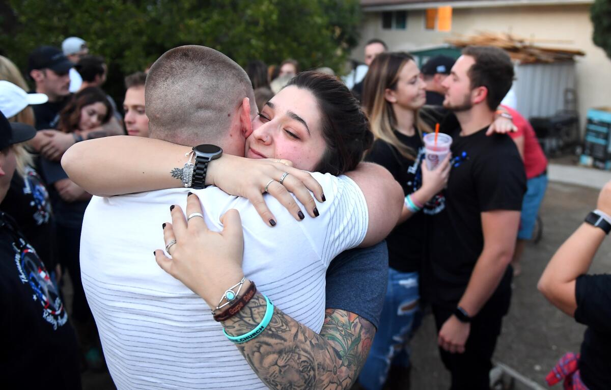 Katie Wilkie and Justin Veditz, survivors of the Bordeline Bar and Grill shooting, embrace each other.