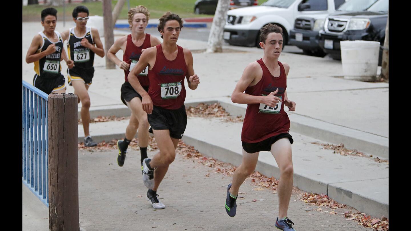 Laguna Beach High's Ryan Smithers, right, Luc La Montagne, center, and Zach Falkowski helped the Breakers take first, second and third place in the Orange Coast League boys' cross-country finals at Centennial Regional Park in Santa Ana on Monday, Oct. 30.