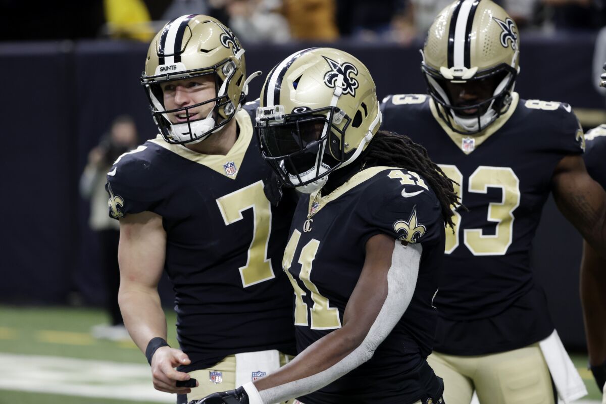 New Orleans Saints quarterback Taysom Hill (7) and running back Alvin Kamara (41) celebrate their touchdown in the second half of an NFL football game against the Carolina Panthers in New Orleans, Sunday, Jan. 2, 2022. (AP Photo/Derick Hingle)