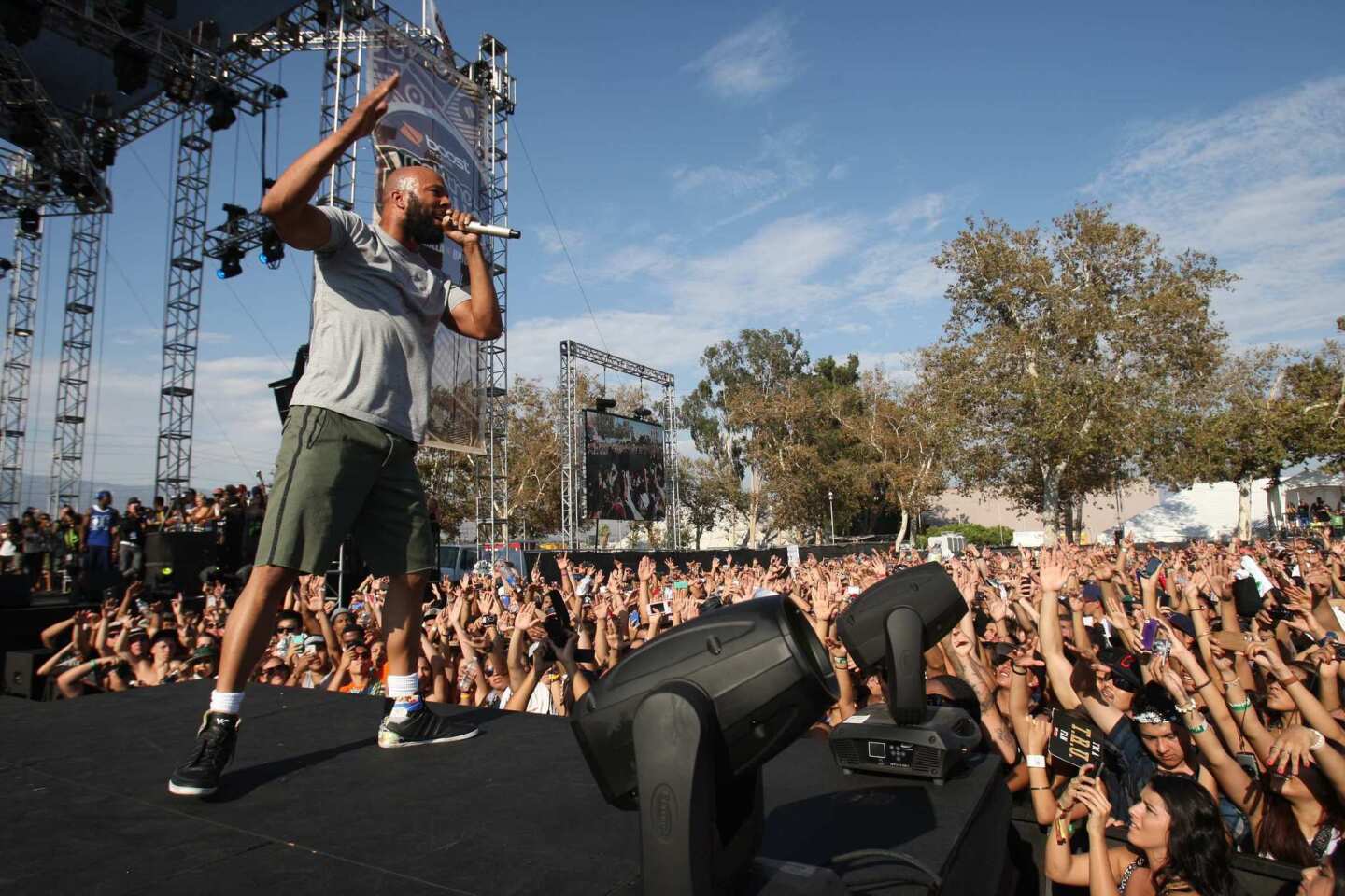 The crowd cheers on Common as he performs during the first day of Rock the Bells at the San Bernardino Nos Events Center.