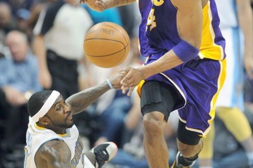 Kobe Bryant steals the ball from Nuggets point guard Ty Lawson in May 2012 but is called for a foul during a game in Denver.
