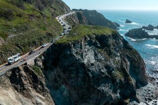 Big Sur, CA - April 02: A convoy of vehicles are led through a closed section of Hwy. 1 as Caltrans crews assess damage after the road slipped out south of the Rocky Creek Bridge on Tuesday, April 2, 2024 in Big Sur, CA. (Brian van der Brug / Los Angeles Times)