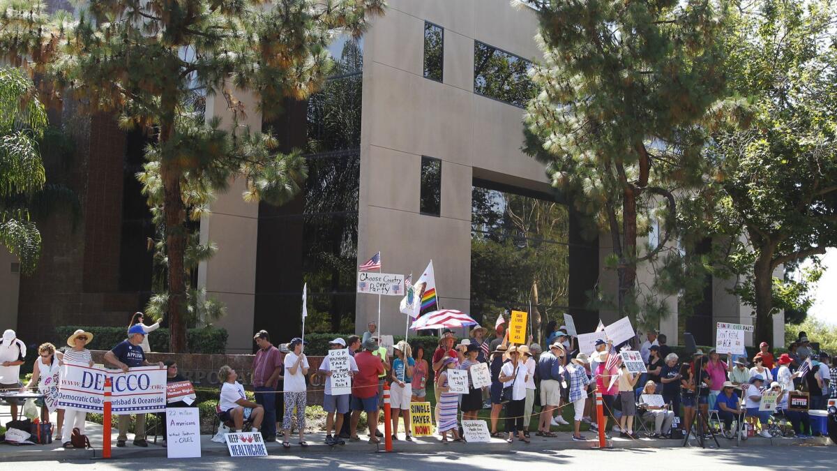 Protesters rally outside Issa's office in July 2017.