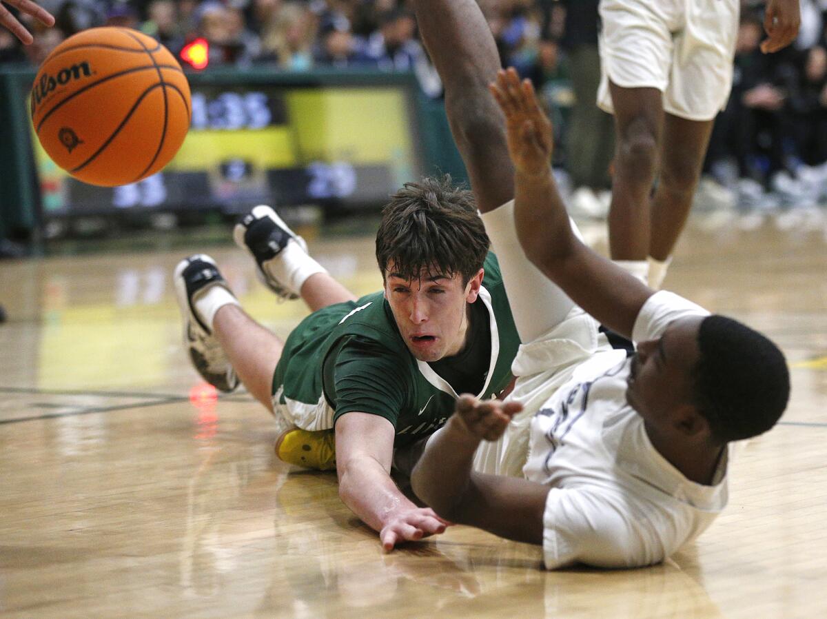 Sage Hill's Johnny Mayhew (34) dives for a loose ball during Saturday's game.