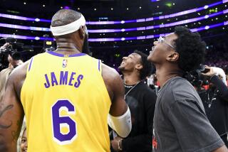 LOS ANGELES, CA - APRIL 29: LeBron James celebrates with his son's Bronny and Bryce Maximus after becoming the all-time NBA scoring leader, passing Kareem Abdul-Jabbar at 38388 points during the third quarter against the Oklahoma City Thunder at Crypto.com Arena on Tuesday, Feb. 7, 2023 in Los Angeles, CA. (Wally Skalij / Los Angeles Times)