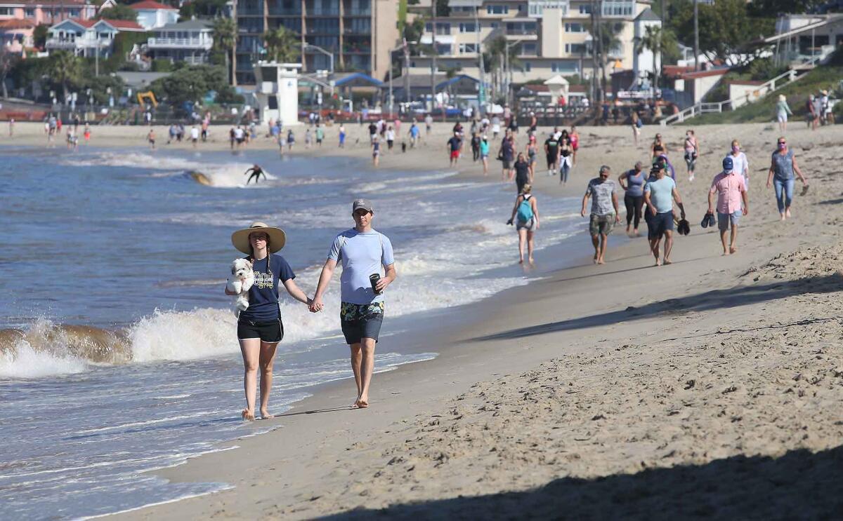 Beachgoers walk the sands between Cleo Street Beach and Main Beach on May 5.