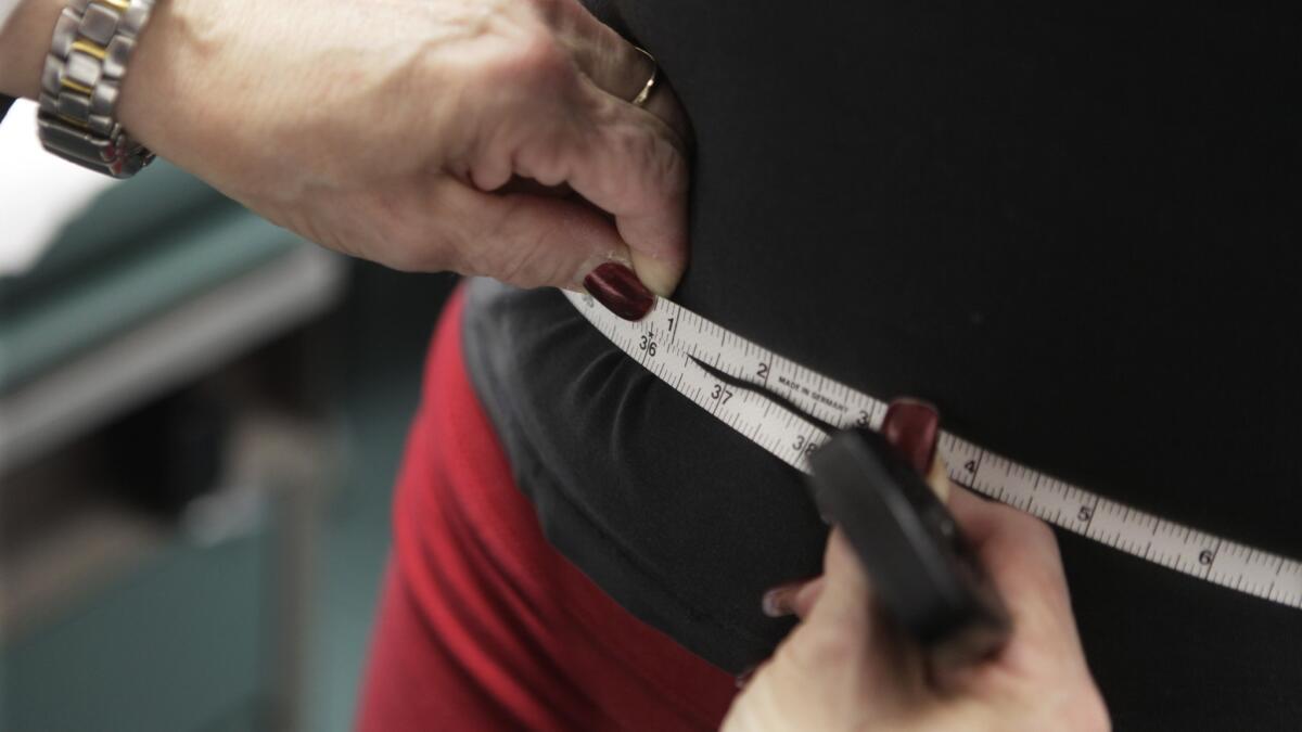 A waist is measured during an obesity prevention study at Rush University Medical Center in Chicago.