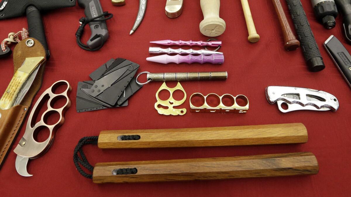 Nunchucks, bottom, are shown in 2017 at Seattle-Tacoma International Airport among objects confiscated from carry-on luggage. A federal court says New York's ban on the weapon made famous by Bruce Lee is unconstitutional.
