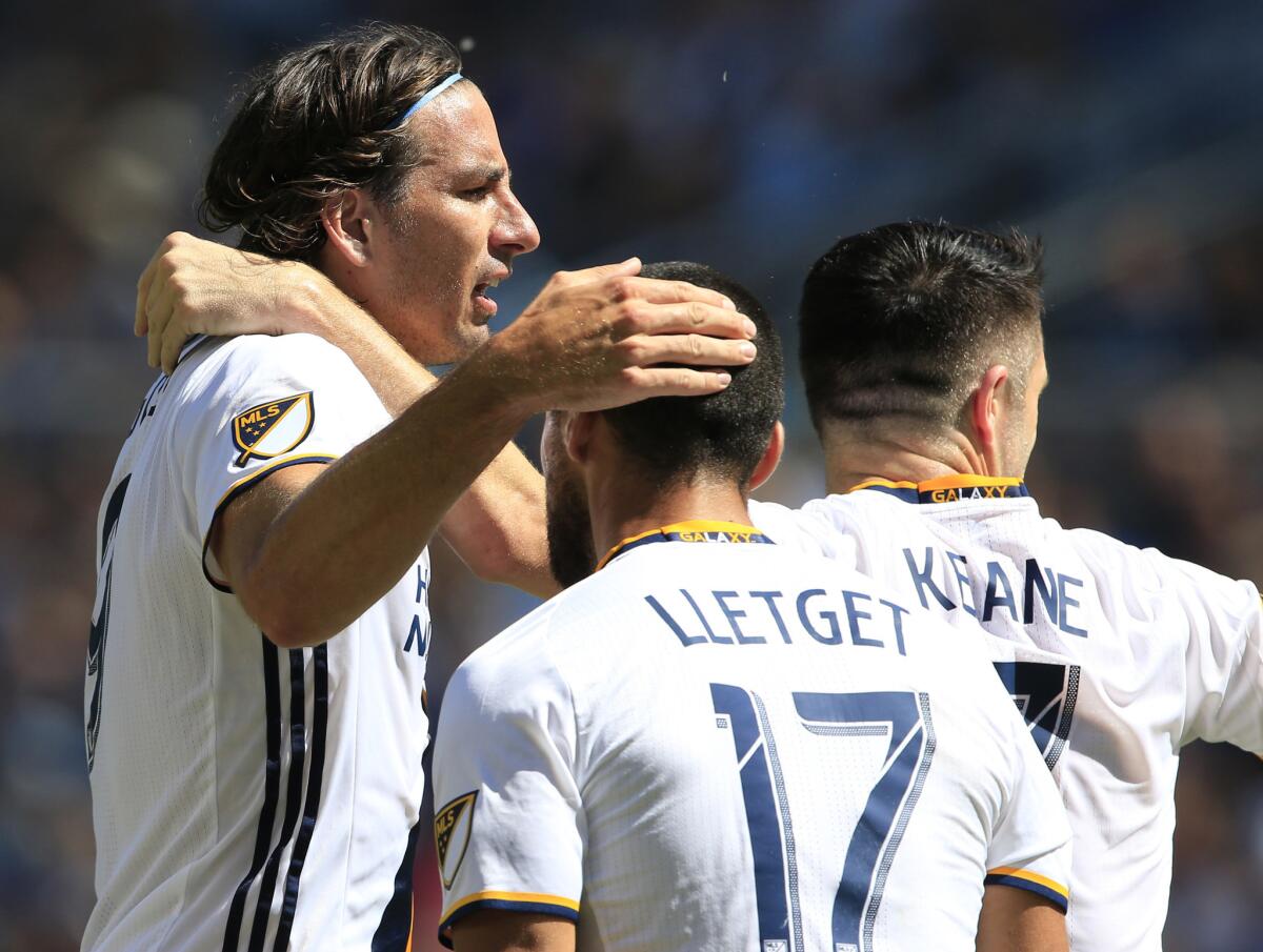 Galaxy forward Alan Gordon, left, celebrates his goal with teammates Sebastian Lletget (17) and Robbie Keane (7) during the first half of a match against Sporting Kansas City on Sept. 18.