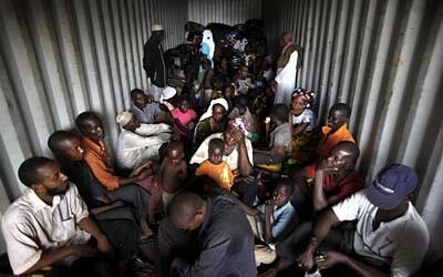Muslim refugees fill the back of a semi-trailer bound for Cameroon as they flee the violence in the Central African Republic.
