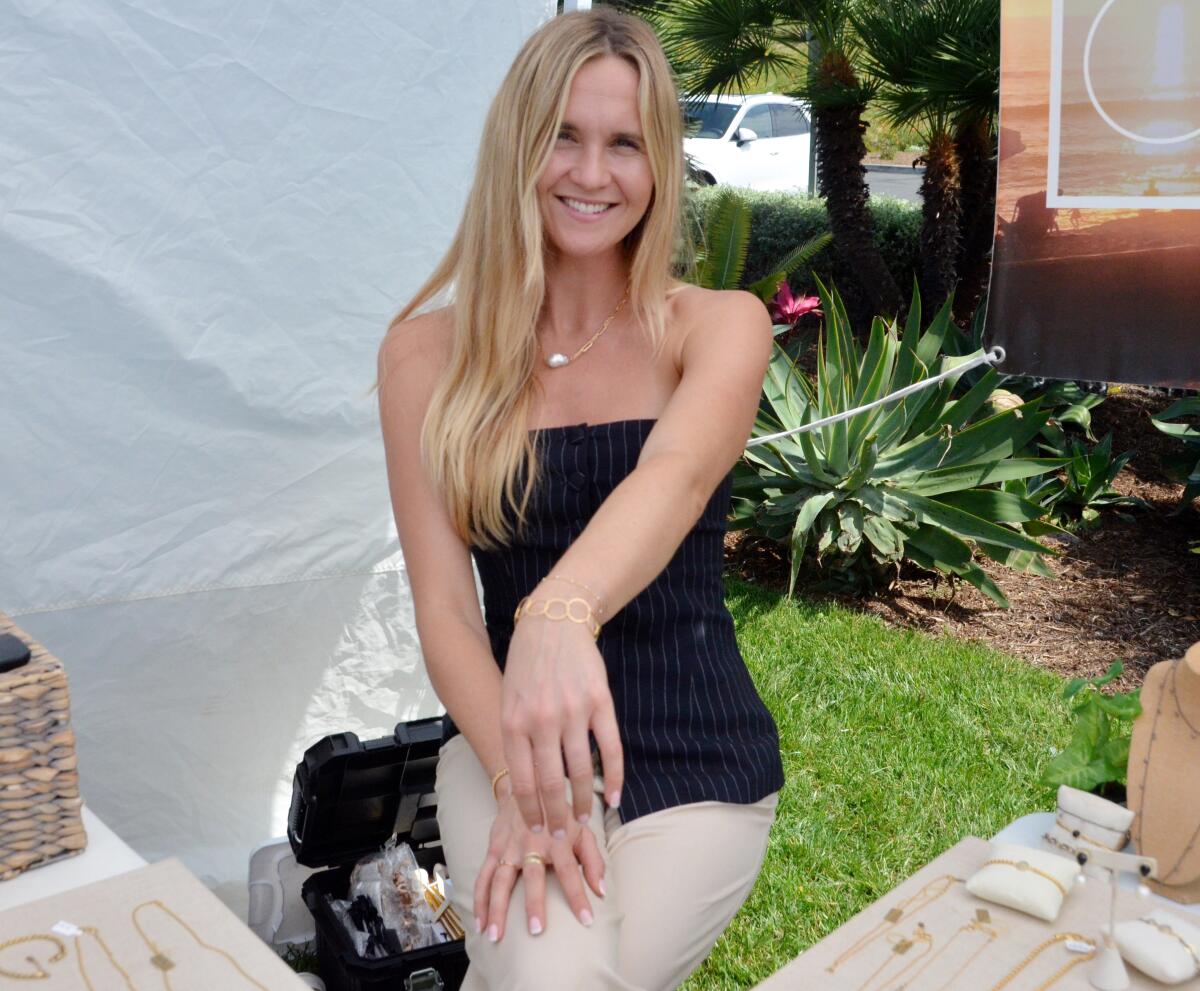 Jewelry designer Christiana Layman shows off her circle-connection gold-filled bracelet at Art in the Park.