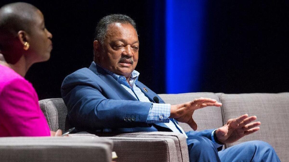 The Rev. Jesse Jackson speaks at the Irvine Barclay Theatre on Friday alongside UC Irvine law Professor Michele Goodwin. “There’s a struggle today for the soul of America," Jackson said.