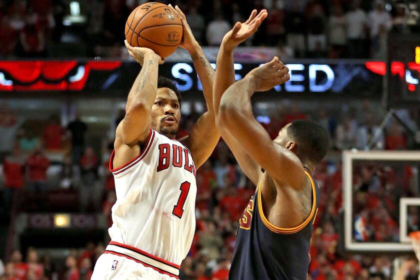 Bulls point guard Derrick Rose (1) takes the game-winning shot over Cavaliers forward Tristan Thompson in Game 3 of their first-round playoff series Friday night in Chicago.