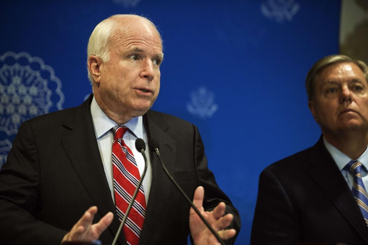 Republican Sens. John McCain of Arizona, left, and Lindsey Graham of South Carolina address a news conference in Cairo.