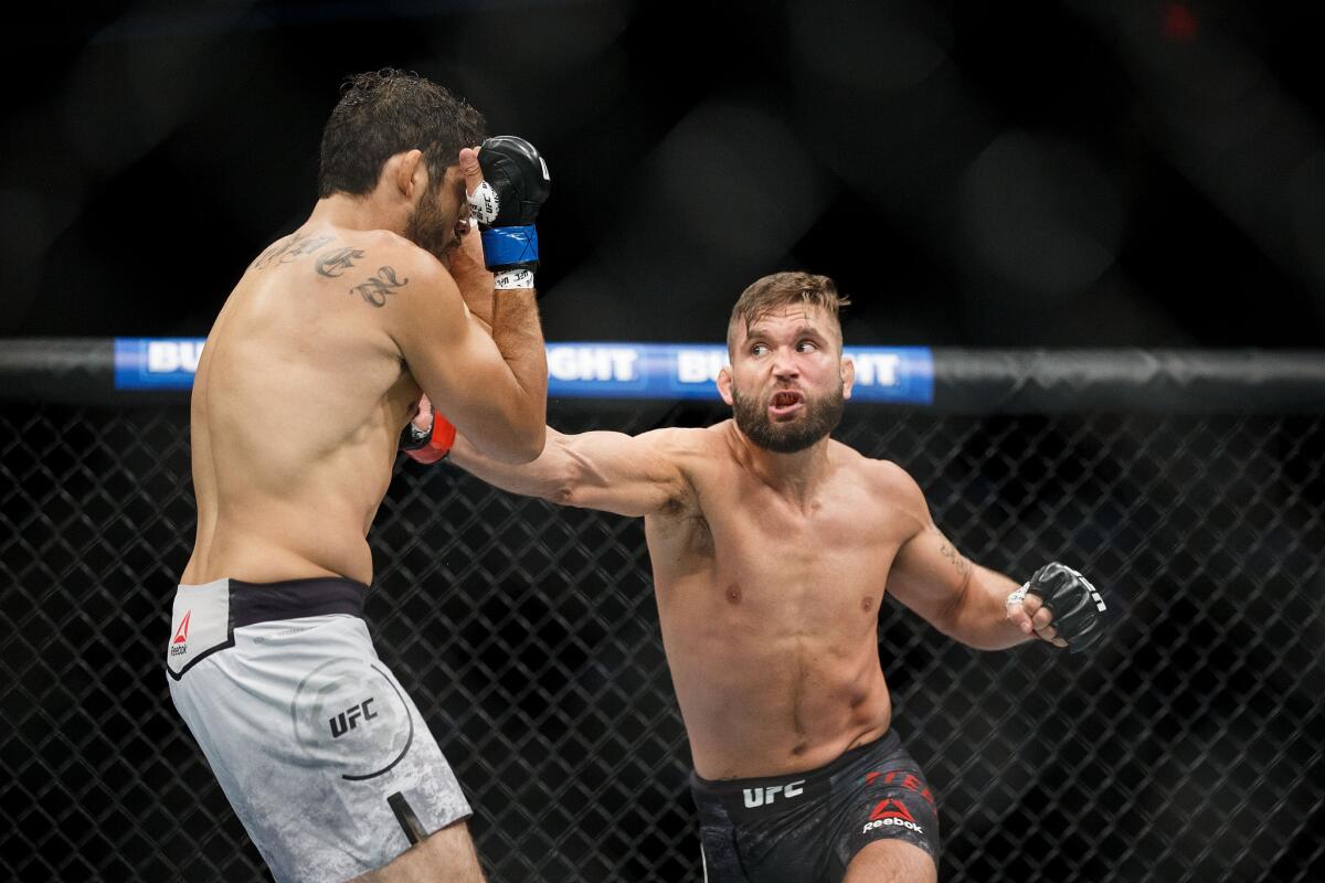 Jeremy Stephens, right, goes on the offensive against Gilbert Melendez during their bout at UFC 215.