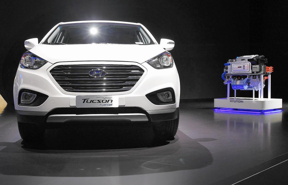 Hyundai started leasing a hydrogen fuel cell version of its Tucson SUV, above, this year. To the right is a fuel cell stack on display at the 2013 L.A. Auto Show.