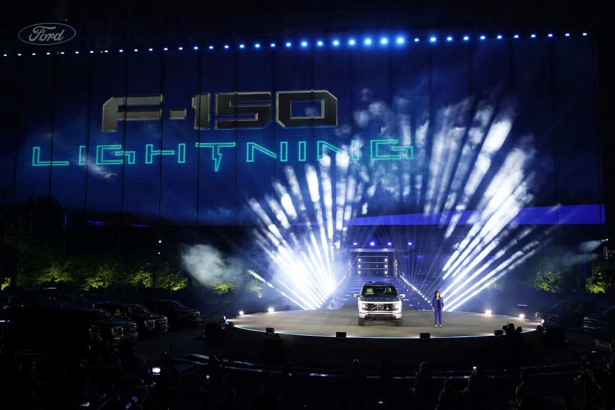 FILE - Ford's Chief Executive Engineer Linda Zhang unveils the Ford F-150 Lightning, Wednesday, May 19, 2021, in Dearborn, Mich. United Rental said Tuesday, May 10, it has a deal to buy 500 of Ford’s F-150 Lightning electric trucks and 30 of its E-Transit electric vans. United Rental expects 120 of the trucks and all 30 of the vans to be delivered and deployed this year as part of its goal to reduce its fleet’s greenhouse gas emissions. (AP Photo/Carlos Osorio, File )