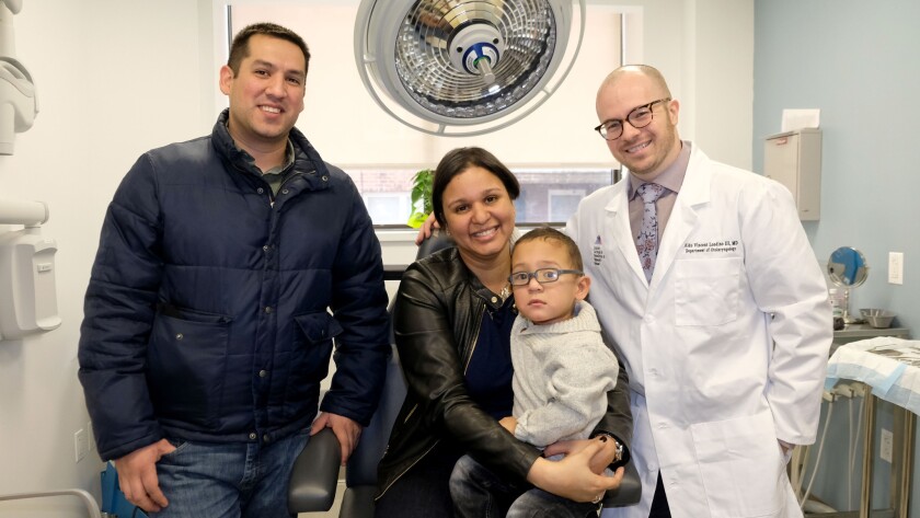 Dr. Aldo Londino poses for a photo with his little patient, Ein Sanchez, and parents Julissa Molina and Jack Sanchez at Mount Sinai Hospital on Wednesday. This will be the first Thanksgiving where the toddler can have a meal with his family instead of being fed through a tube.