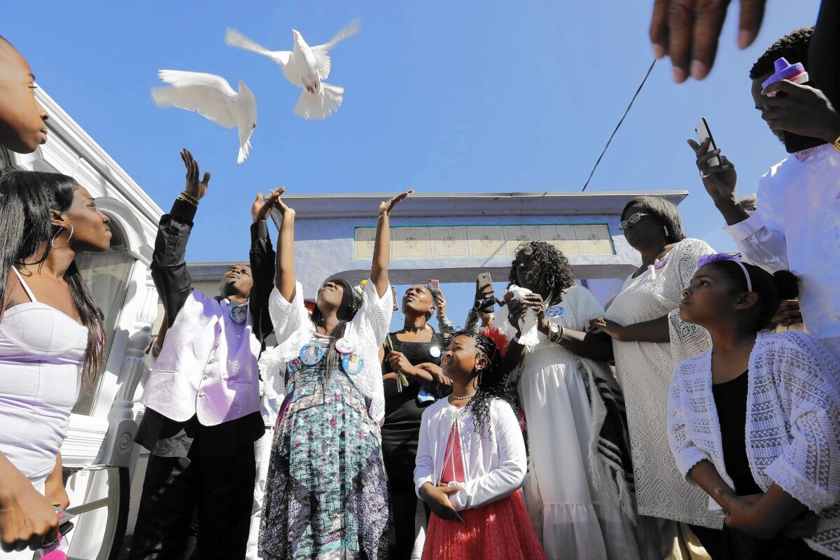 Darrell Johnson and Blanche Wandick, Autumn Johnson's parents, release doves in their daughter's memory at Angeles Abbey Memorial Park.