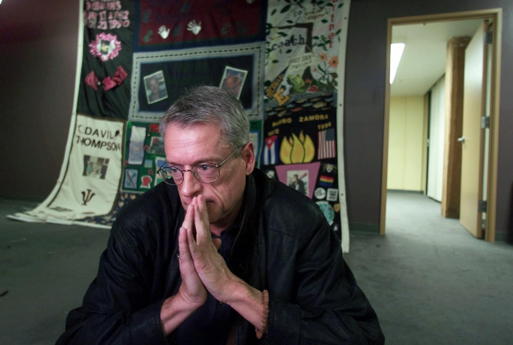 March 2001 photo, Cleve Jones, founder of the AIDS Memorial Quilt, sitting on the floor of nearly-empty offices.