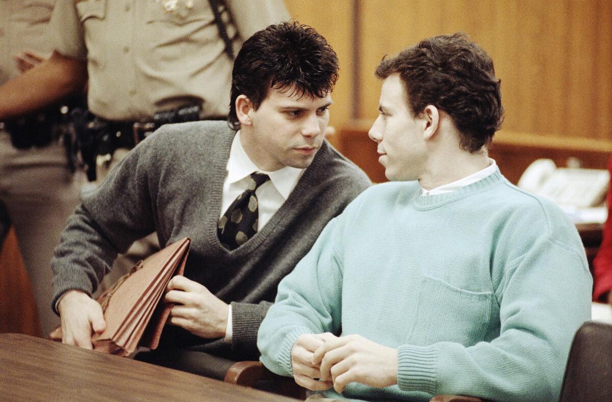 Lyle Menendez, left, confers with brother Erik during a court appearance.