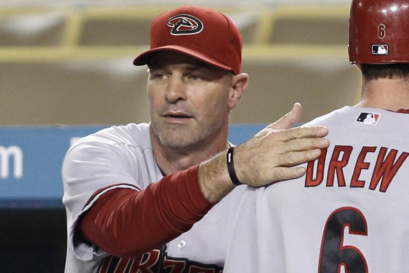 Arizona Diamondbacks Manager Kirk Gibson congratulates Stephen Drew after he scored on a double during a game against the Dodgers in 2010. Gibson has been diagnosed with Parkinson's disease.