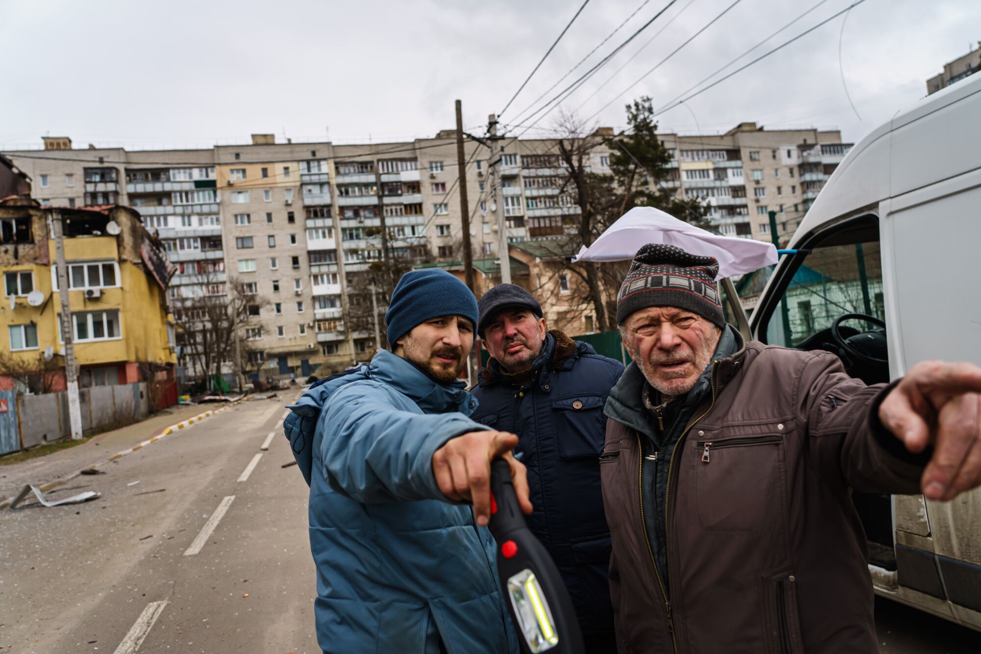 Maxim Chevchenko talks to local residents in Irpin.  