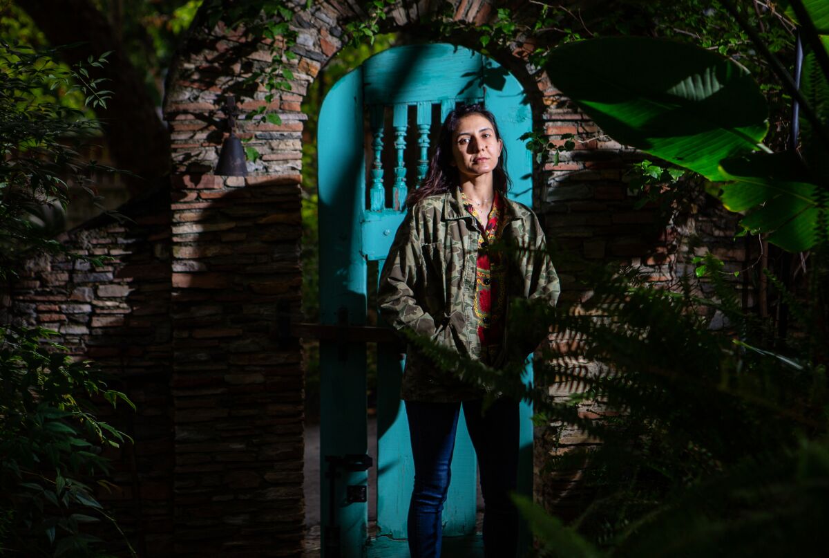 Author Ottessa Moshfegh poses for a portrait in the lush gardens surrounding her home.