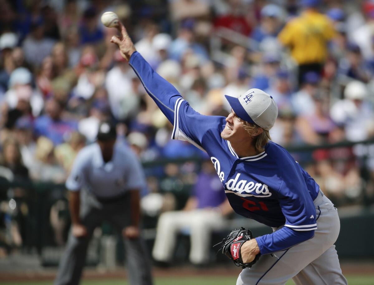 Dodgers starting pitcher Zack Greinke fires a pitch in a spring training game in Mesa, Ariz.