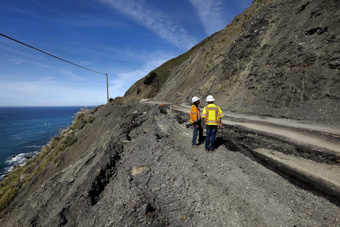 Caltrans inspector Tony Pascual, left, and construction engineer Wayne Walker examine a landslide that took out the southbound lane and shoulder on Highway One, in a section known as Mud Creek along the Big Sur coast.