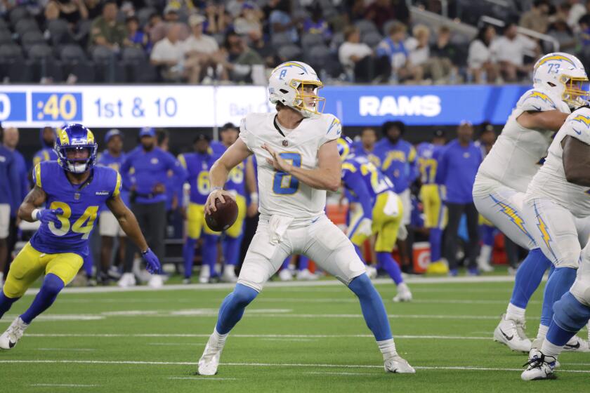 Chargers quarterback Max Duggan looks to pass against the Rams in a preseason game.