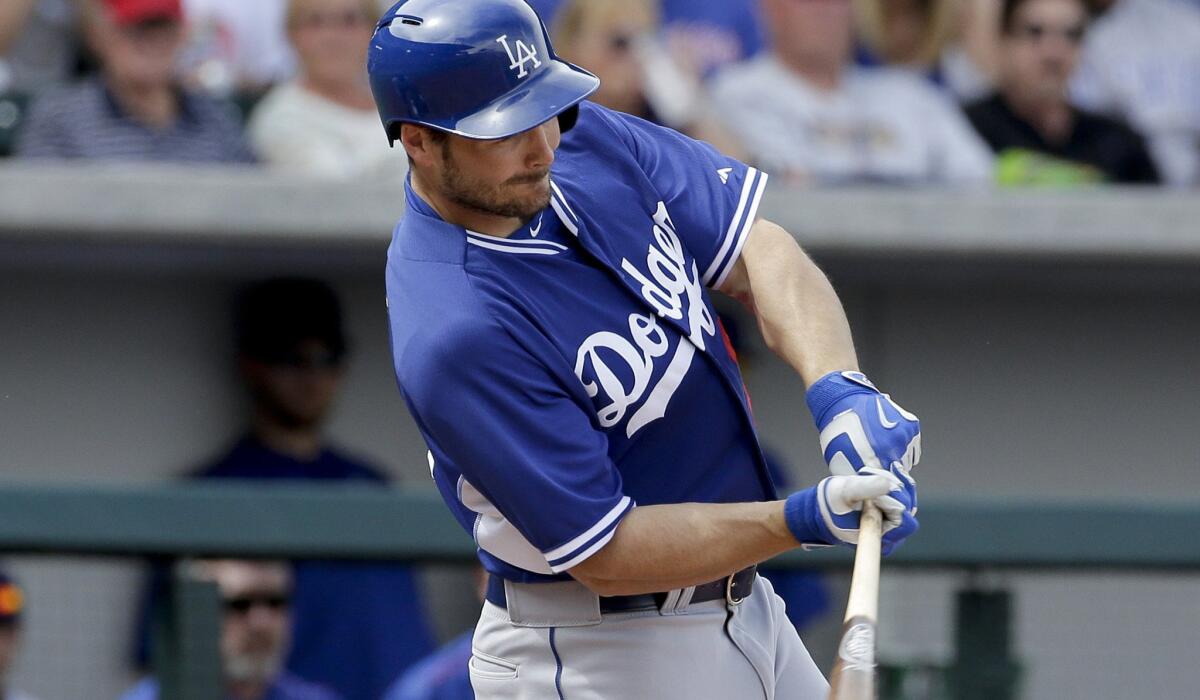 Dodgers outfielder Chris Heisey fouls off a pitch during an exhibition game against the Cubs on March 11.