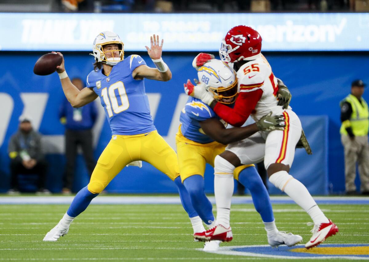 Chargers quarterback Justin Herbert throws a 50-yard touchdown pass to Joshua Palmer in the first quarter Sunday.