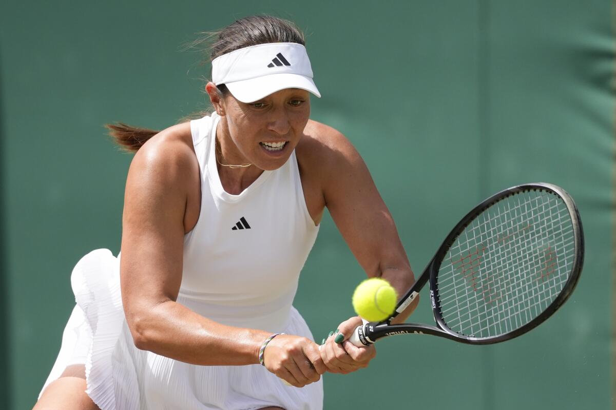 Jessica Pegula hits a return during her second-round loss to Xinyu Wang at Wimbledon.