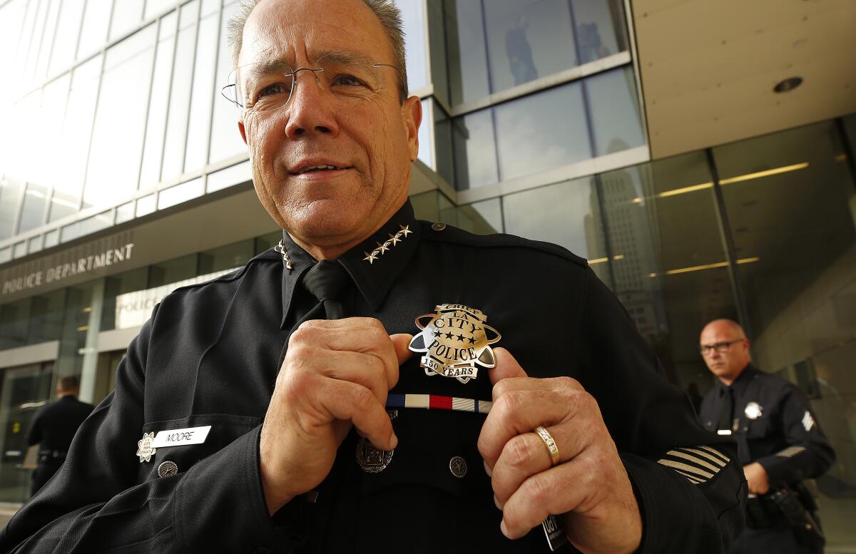 LAPD Chief Michel Moore wears his 150th anniversary badge during the unveiling at police headquarters. About 2,000 officers will wear a nearly identical badge of those worn by officers in 1869.