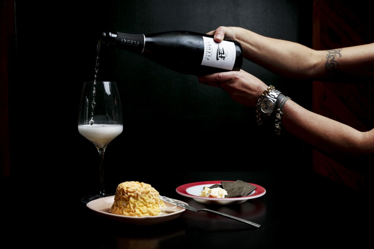Lydia Clarke pours a glass of Champagne Fleury with a serving of Langres cheese at Kippered Bar