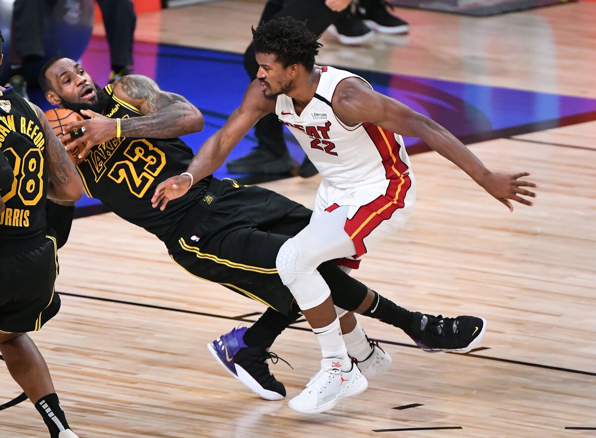 Lakers forward LeBron James collides with Heat forward Jimmy Butler during the fourth quarter of Game 5 on Friday night.