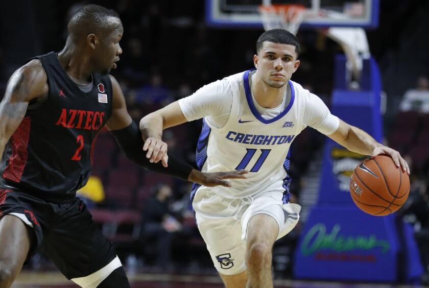 FILE - Creighton's Marcus Zegarowski (11) drives around San Diego State's Adam Seiko (2) during the first half of an NCAA college basketball game in Las Vegas, in this Thursday, Nov. 28, 2019, file photo. Zegarowski announced he's leaving Creighton and declaring for the NBA draft. “I will be entering the 2021 NBA draft and look forward to continuing to work hard, chase my dreams and play the game I love,” Zegarowski tweeted Tuesday, April 13,. 2021. (AP Photo/John Locher, File)