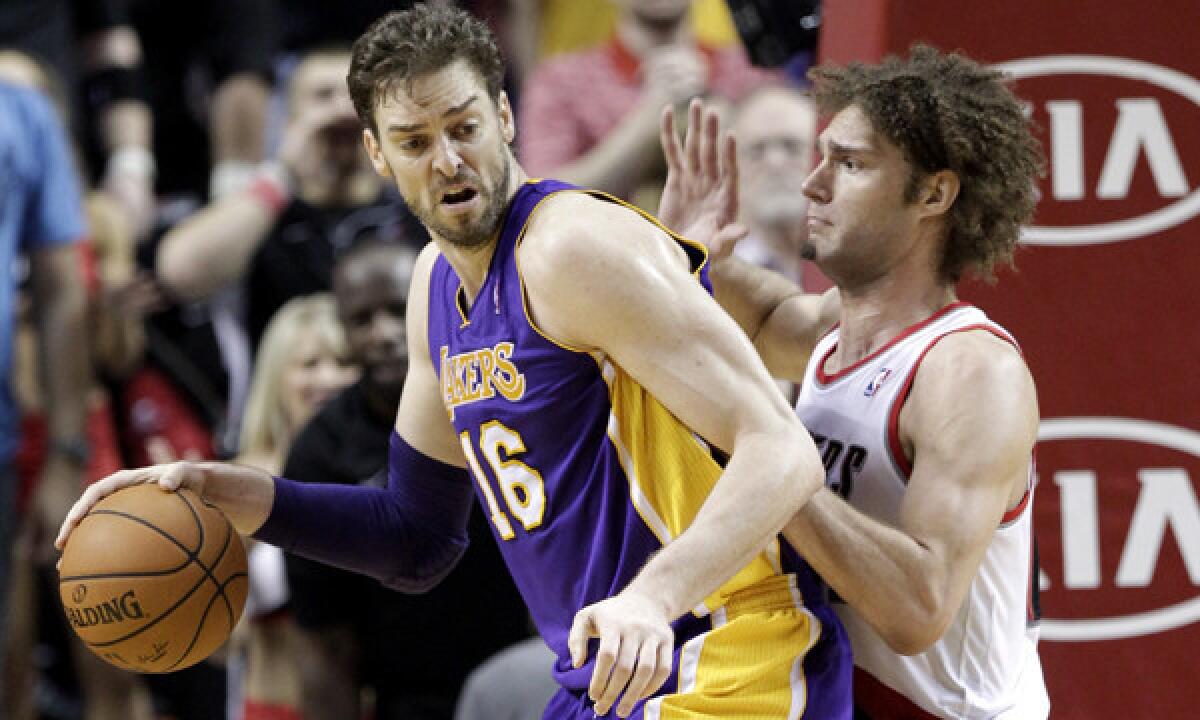 Lakers center Pau Gasol, left, backs in on Portland Trail Blazers center Robin Lopez during the Lakers' 107-106 win on March 3.
