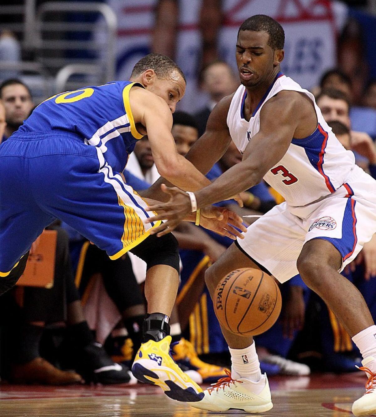 Clippers guard Chris Paul, right, gets one of his six steals by taking the ball from Warriors guard Stephen Curry.