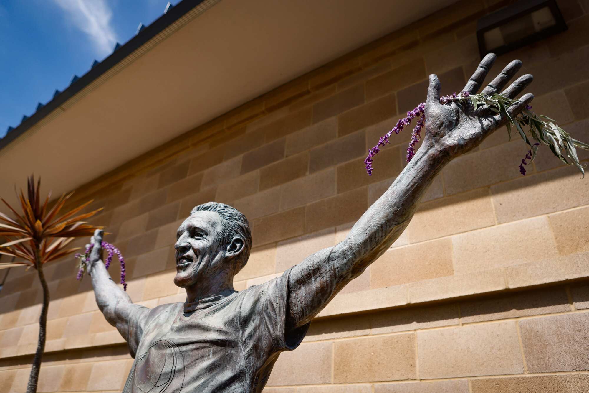 lowers line hands of Bill Walton's statue at the Mission Valley YMCA on Tuesday.