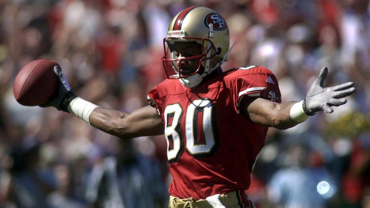 San Francisco 49ers wide receiver Jerry Rice celebrates after scoring a touchdown against the Arizona Cardinals on Oct. 1, 2000.
