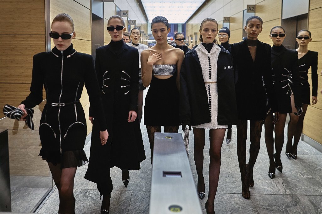 The models from the Alexander Wang show exit the 4 Times Square building in New York for a street-side post-show photo-op.