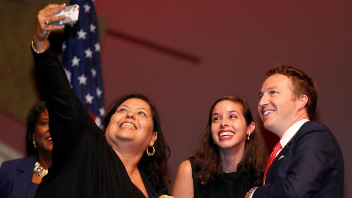 Los Angeles Unified board members Monica Garcia, left, Kelly Gonez and Nick Melvoin pose for a selfie in July.