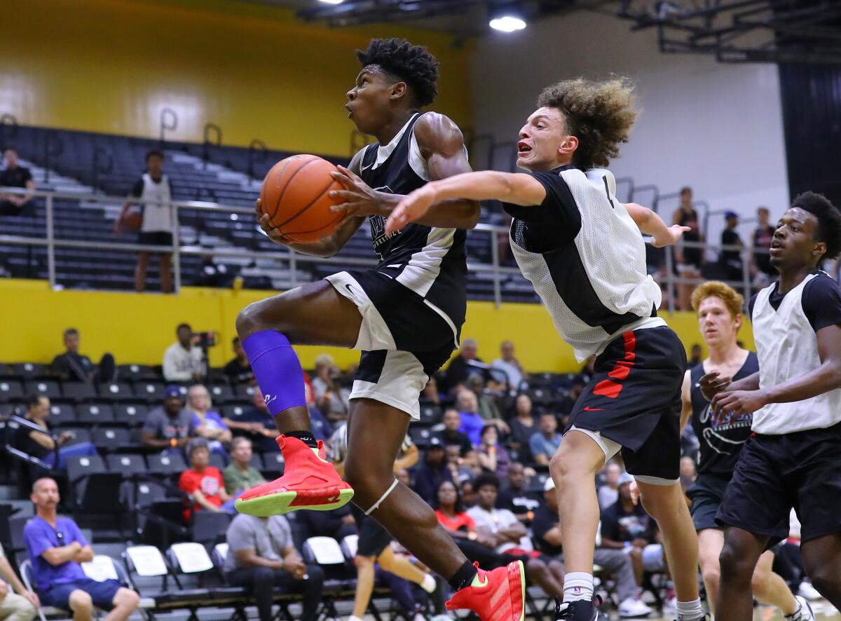 Windward point guard Dylan Andrews goes up for shot as Westchester's T.J. Wainwright defends.