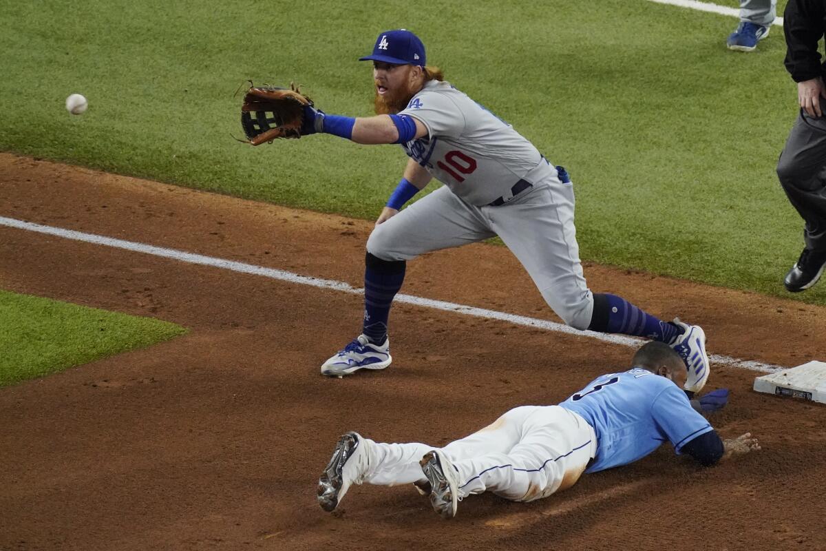 Tampa Bay Rays' Manuel Margot is safe at third past Los Angeles Dodgers third baseman Justin Turner.