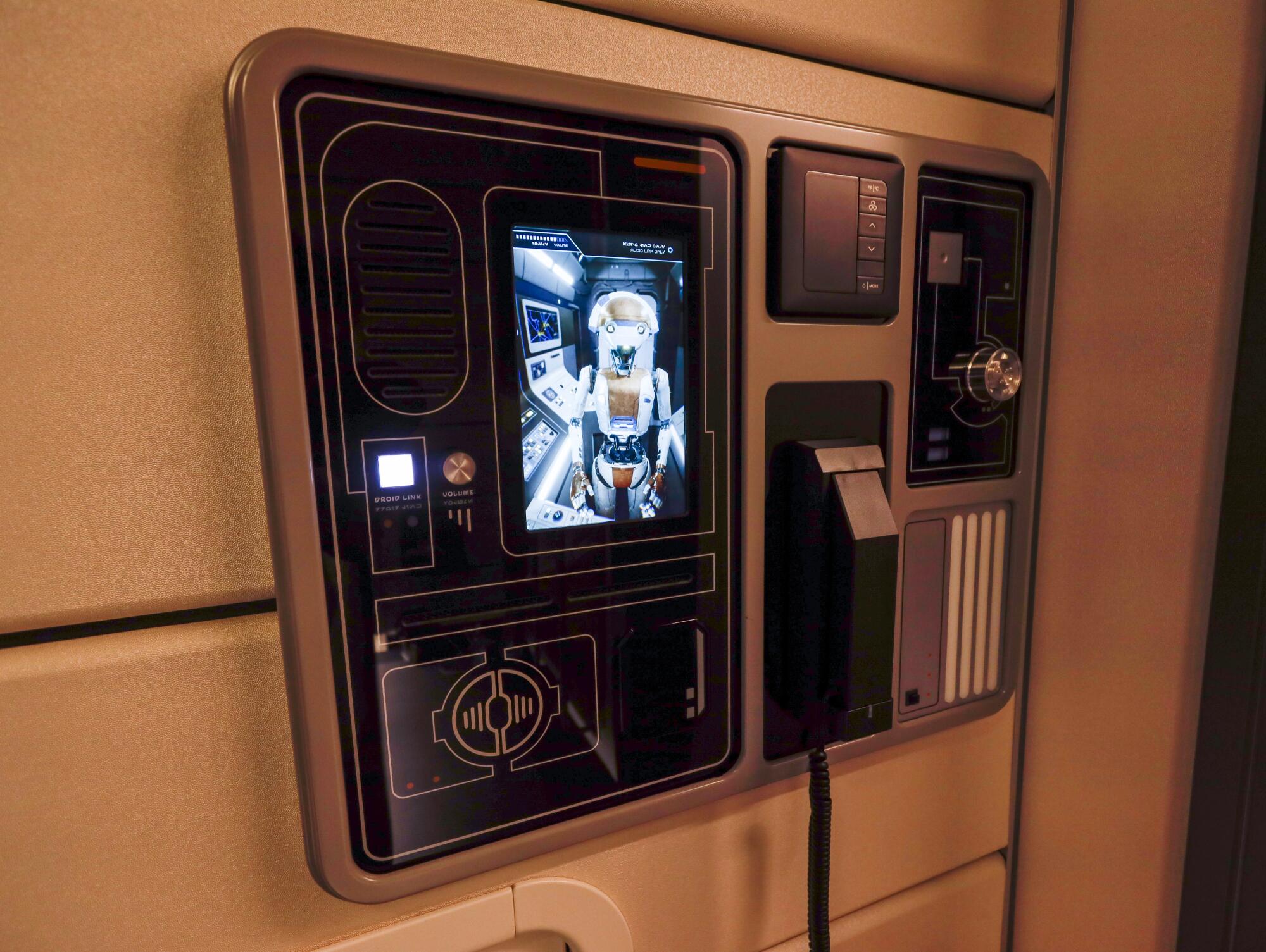 D3-O9, a talkative droid on vidscreens inside rooms at the Halcyon ship, greets guests.