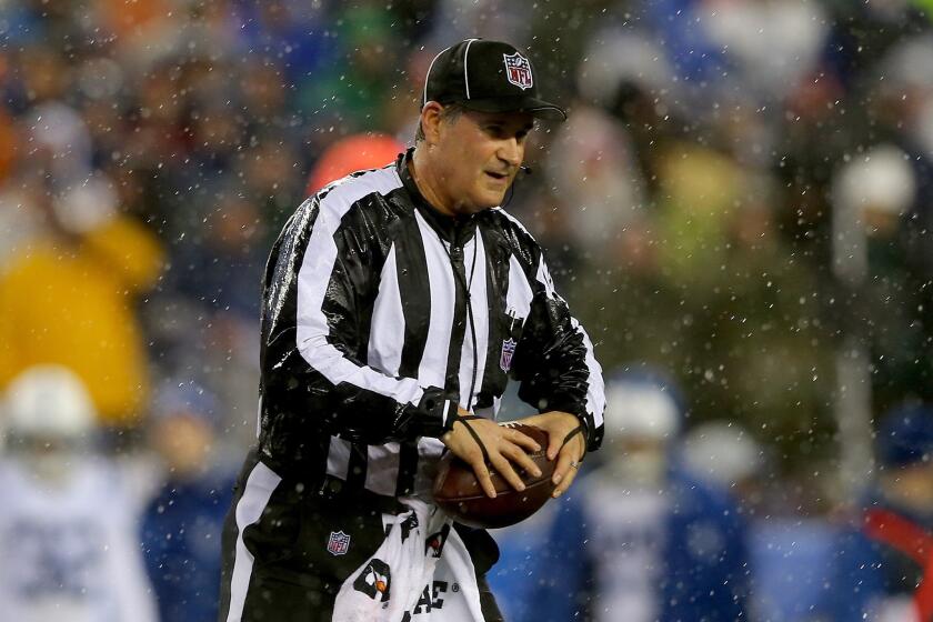 Umpire Carl Paganelli holds a football during the AFC Championship game between the New England Patriots and Indianapolis Colts. The Patriots beat the Colts, 45-7.