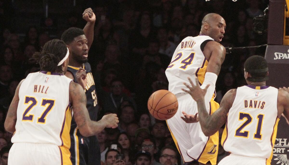 Kobe Bryant flips a backward pass to Jordan Hill in Sunday's game against the Pacers at Staples Center.