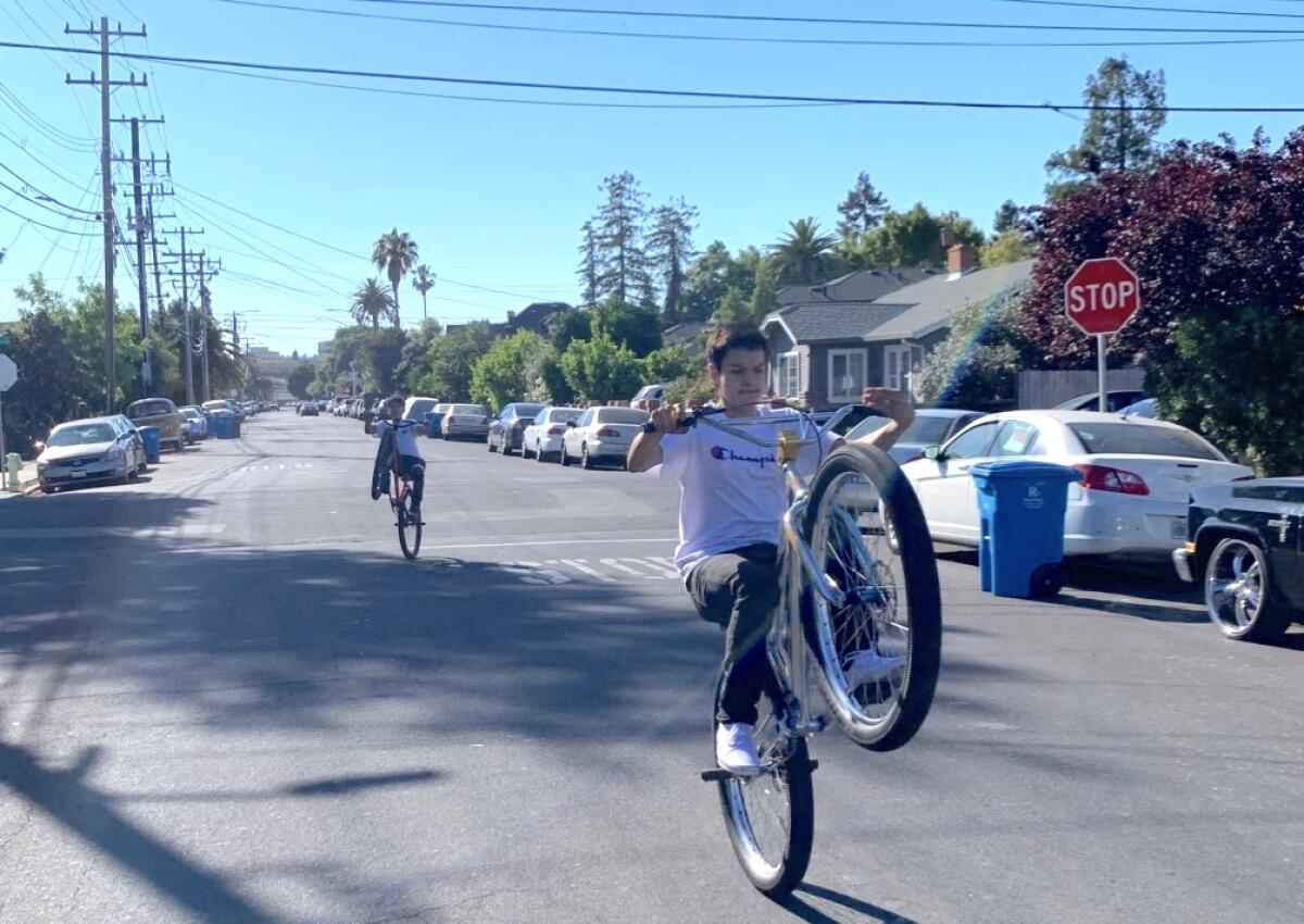 Javier Melendes, front, and Jesse Rivera ride their bikes down one of Redwood City's "Safe Streets."